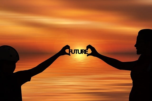 Two people with future sign in sunset