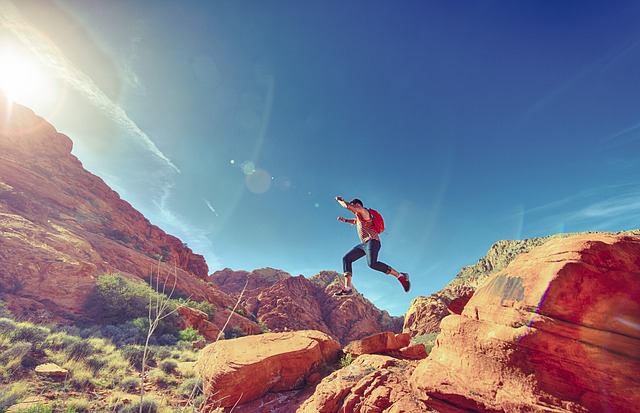 man jumping on rocks