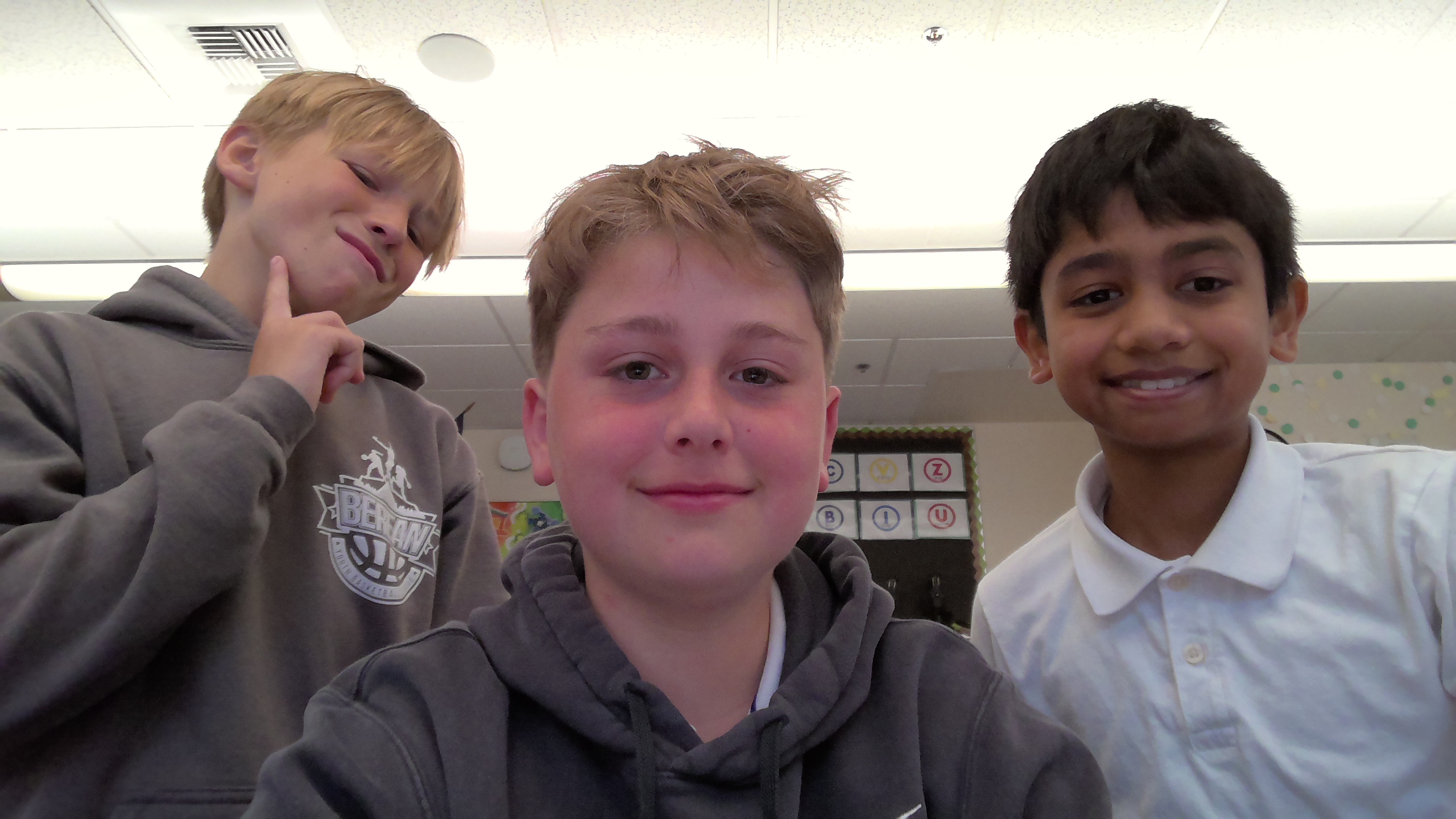 Knox and Kiran smiling while Corban mews