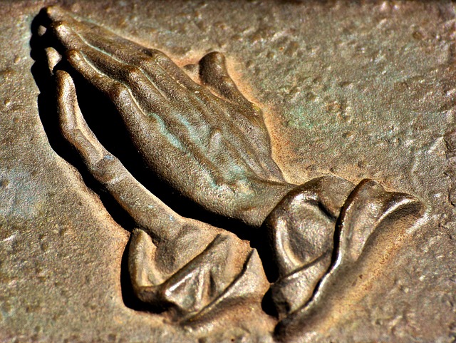 bronze bombastic praying hands
