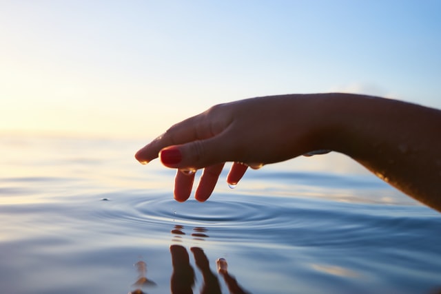 hand touching peaceful water photo