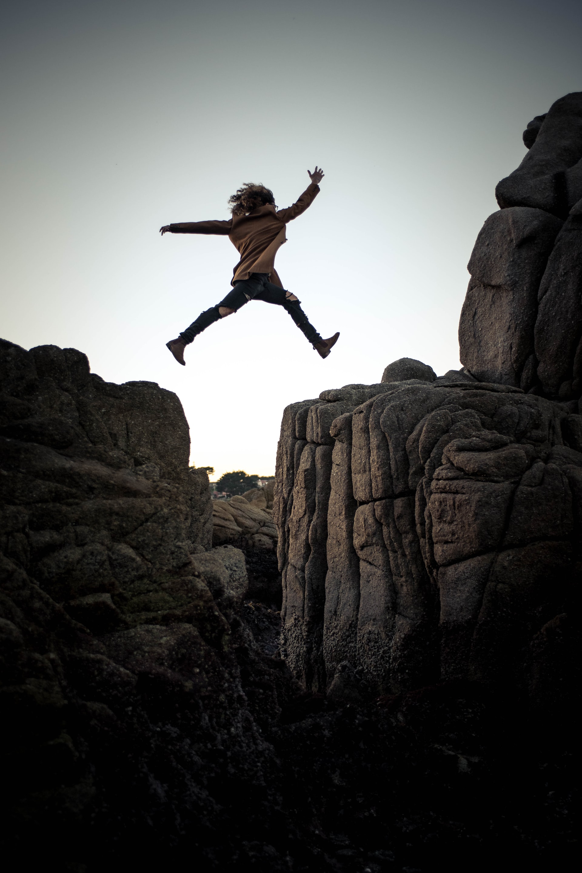 girl jumping to rock