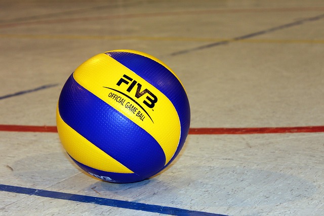 Blue and yellow volleyball on court