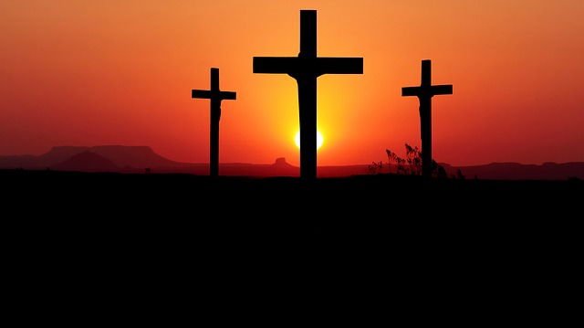 Three crosses on a hill during a sunset