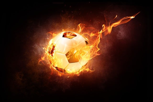 A soccer ball on fire in a black background