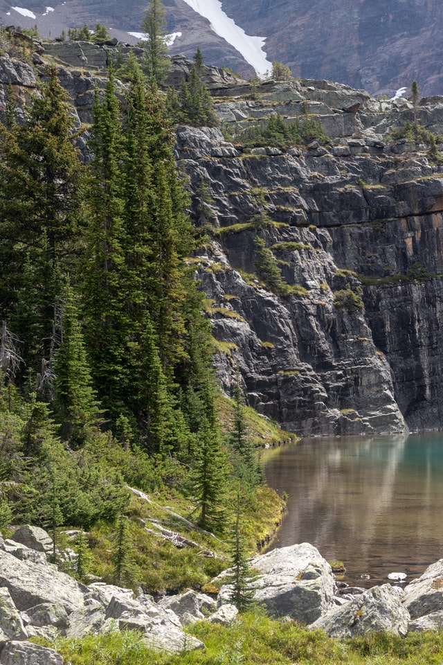 rock cliff with clear lake below