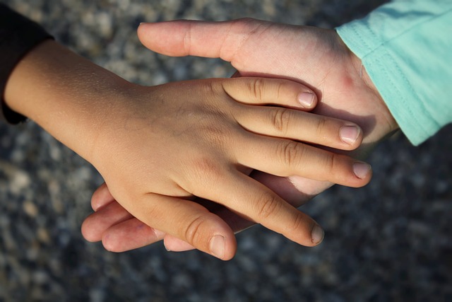 a one hand holding another.