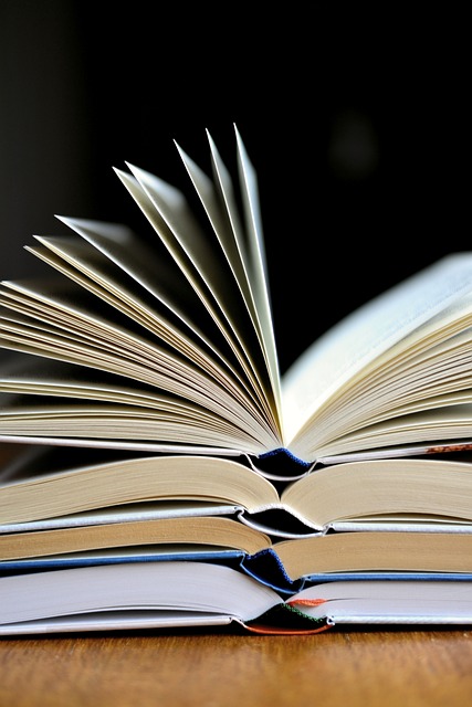 a bunch of books stacked and open