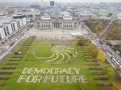 big green field that says democracy for the future