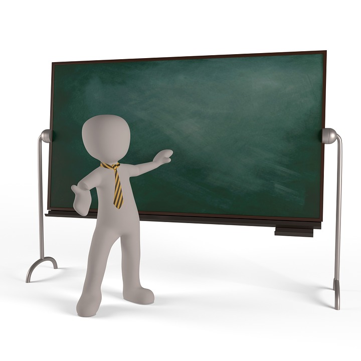 teacher in front of chalkboard