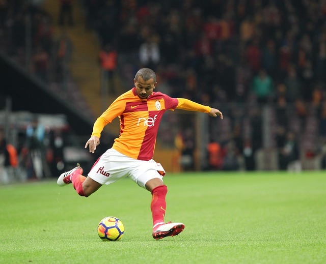 a soccer player kicking a ball