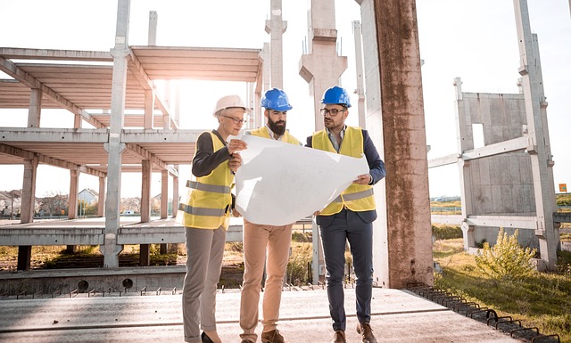 Three people looking at a plan