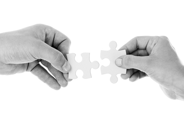 Hand putting puzzle peices together