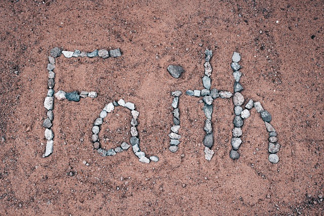 rocks spelling faith on a beach