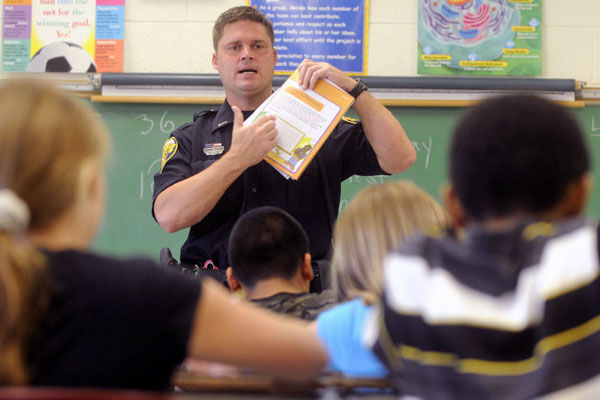 officer teaching kids