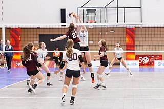 Girls playing a volleyball game