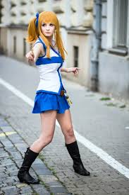 blonde haired girl with a blue accessory and is whearing a white and blue shirt with a blue skirt and black boots