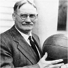 Black and white picture of James Naismath holding a basketball.