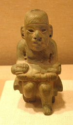 Picture of a brown Olmec wooden figure.