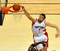 Picture of a player performing a slam dunk by hanging on the rim of a hoop