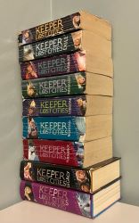 Image of all of the Keeper of the Lost Cities books stacked on top of each other.