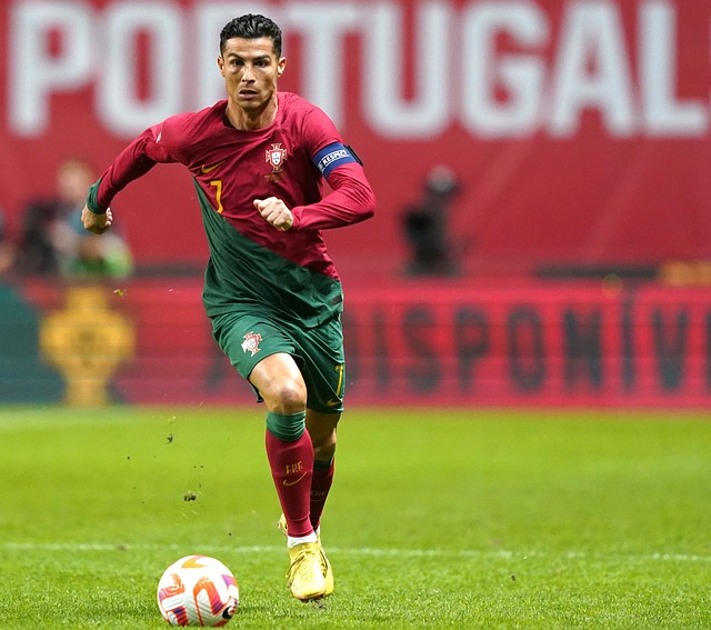 cristiono ronaldo dribbling a soccer ball while playing for portugal