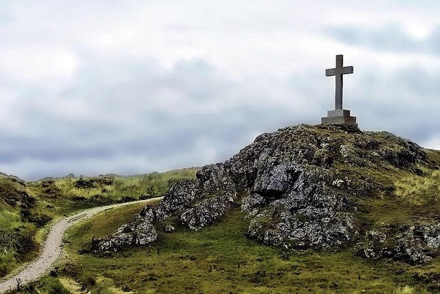 cross with a concreate base on a hill