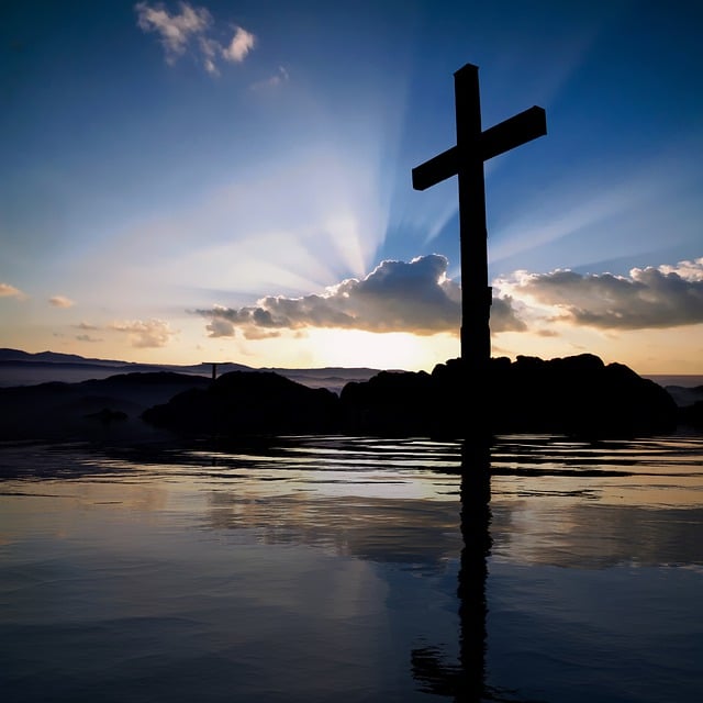 cross on mountain during sunset