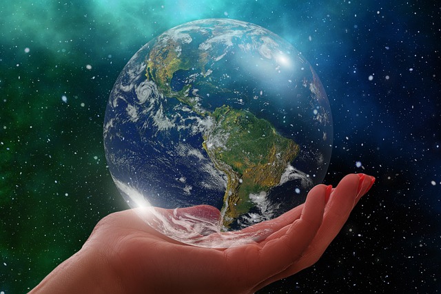 A hand is holding a see-through earth