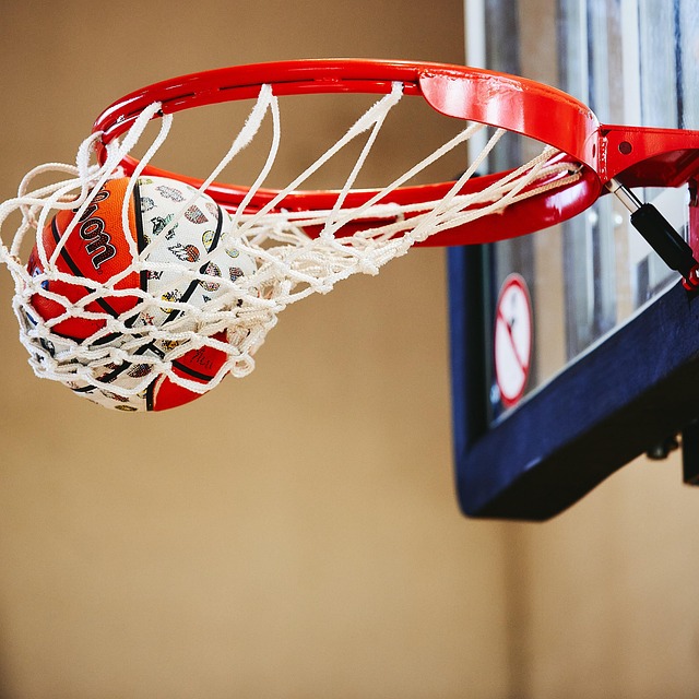 A basket ball gowing into the hoop with a swish.